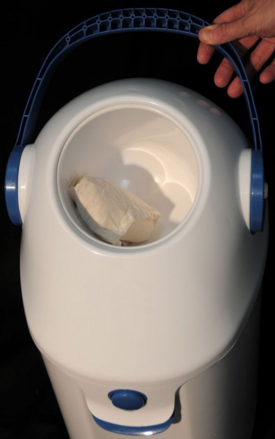 the diaper champ deluxe works by rotating the handle to open...