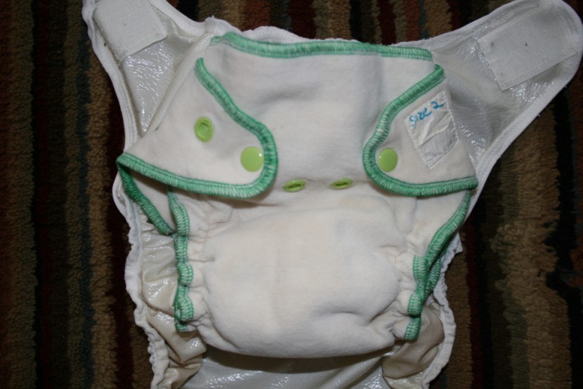 example of a fitted diaper about to be enclosed in a waterproof cover.