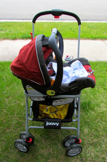 the joovy's uniquely carries car seats in a side-saddle configuration