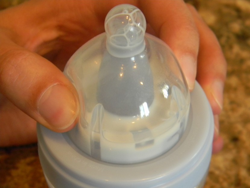 the first years breastflow - squeezing the "milk release tabs" on the breastflow. they help a...
