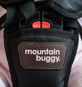 mountain buggy mini - the red safety release buttons on the top of the mini latch must be...
