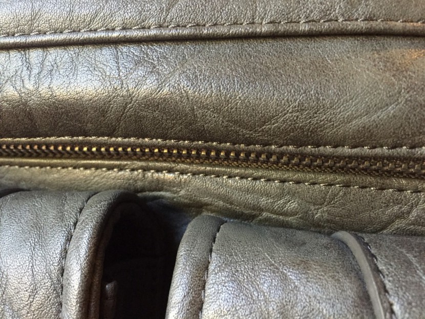 detailing of the metal zipper and stitching on the ness.