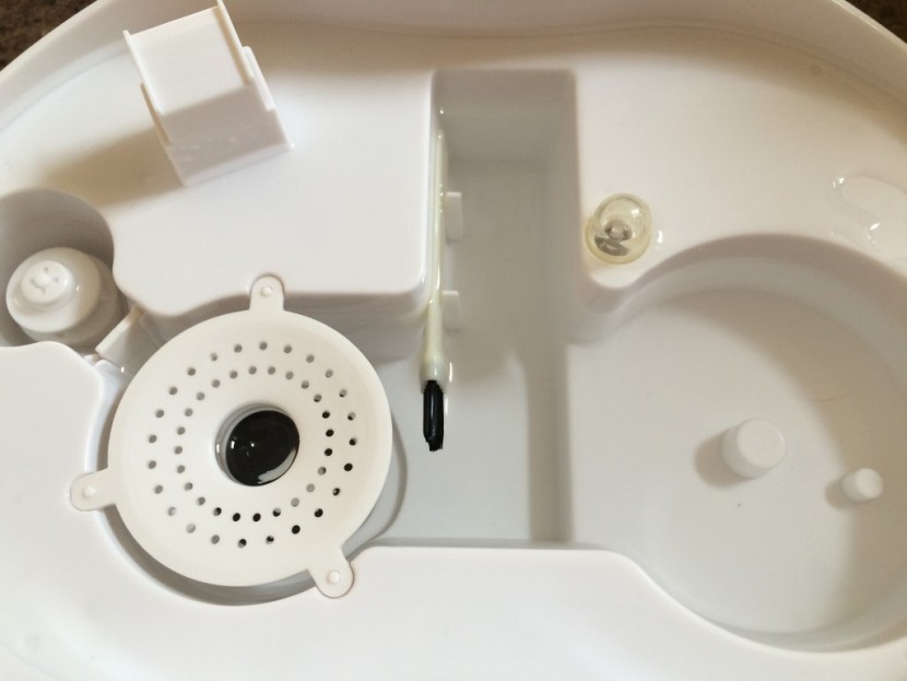 the included cleaning brush for the optimus u-31002 sits in the...