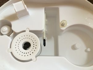 The included cleaning brush for the Optimus U-31002 sits in the...