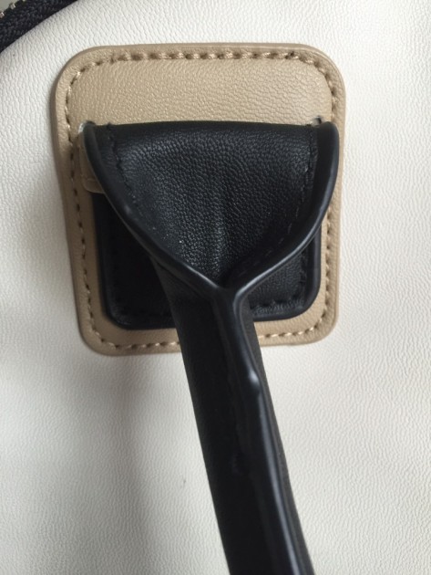 underside of the faux leather detailing on one of the handles.  we...