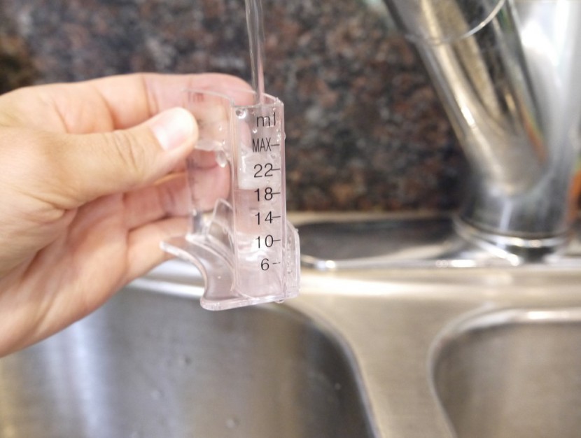 filling the small measuring vial of the cuisinart bw-10 to the...