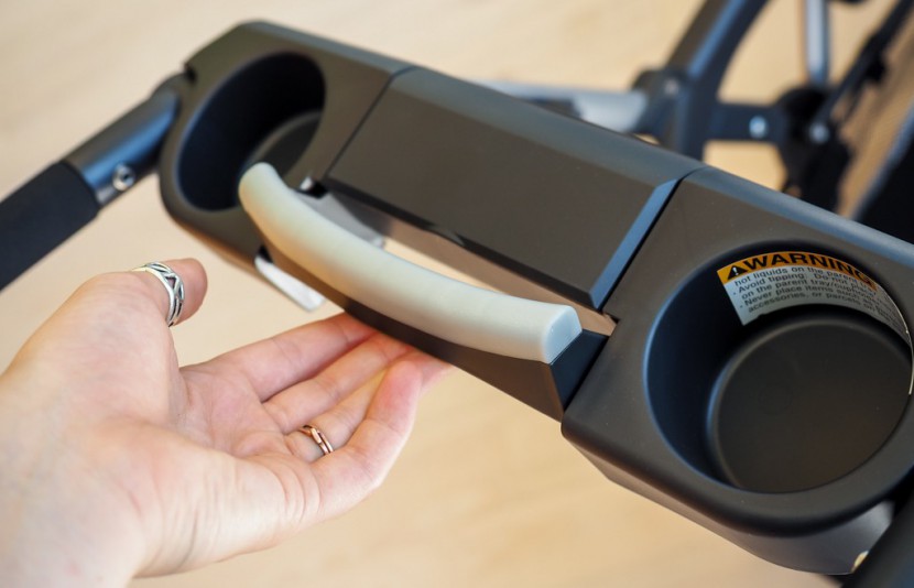 chicco keyfit caddy - folding the caddy begins with the pull of the lock release handle.