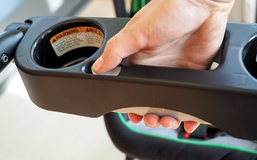 graco snugrider elite - folding the snugrider starts with the release button on the handlebar.