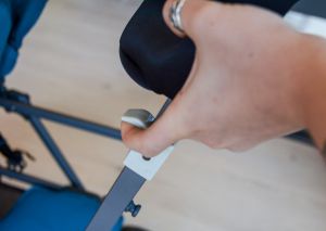 Folding the Caboose starts with releasing the stroller by pulling up...