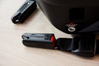 The Peg Perego has anchors that resemble slim seat belts that push...