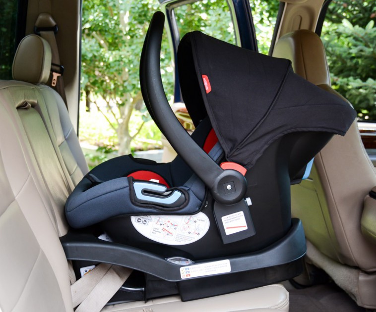 phil and teds alpha is shown above installed in the center seat in a...