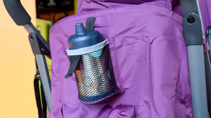 the groove has a mesh cup holder on the back of the canopy above a...