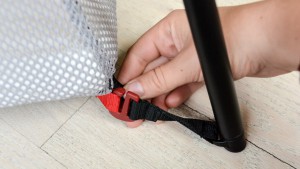 The mattress of the BabyBjorn connects to the legs via color-coded...