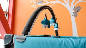 The Graco comes with a mobile that attaches to the side rails.