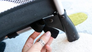 The mattress of the Graco secures to the bottom of the crib with...