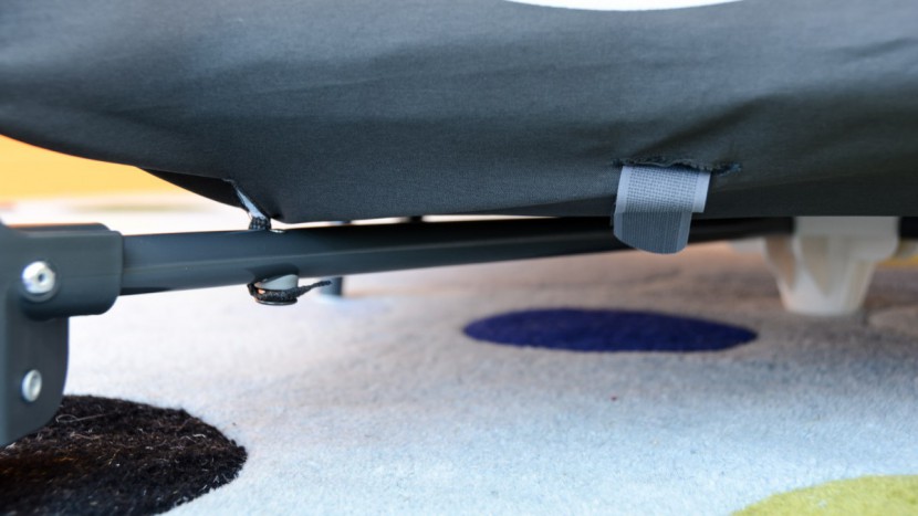 the graco crib bottom secures to the frame with a snap.