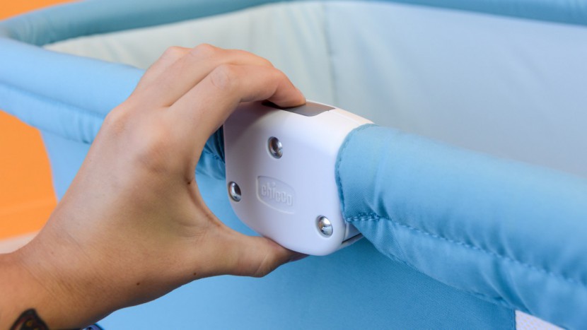 chicco lullago - the side rails on the chicco have a lock/release button to initiate...
