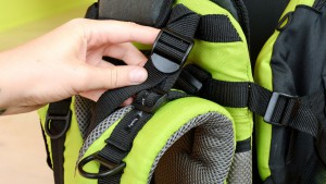 Adjusting the Kiddy shoulder strap height involves unthreading the...