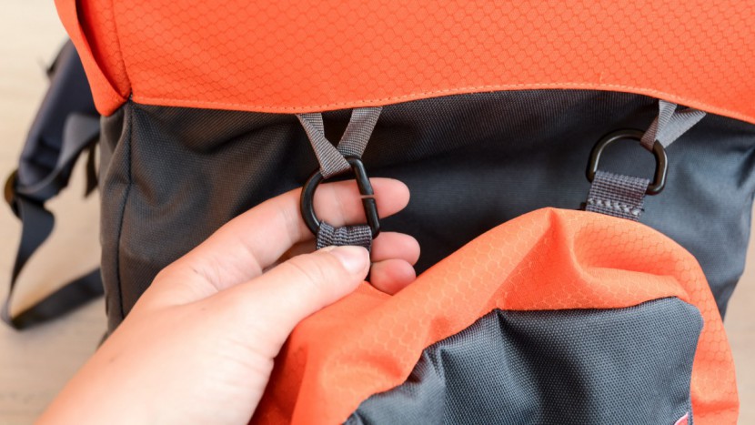 detaching the parade child's pack requires sliding the loop through...