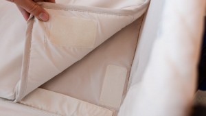 The pad on the Arm's Reach attaches to the bassinet with Velcro.