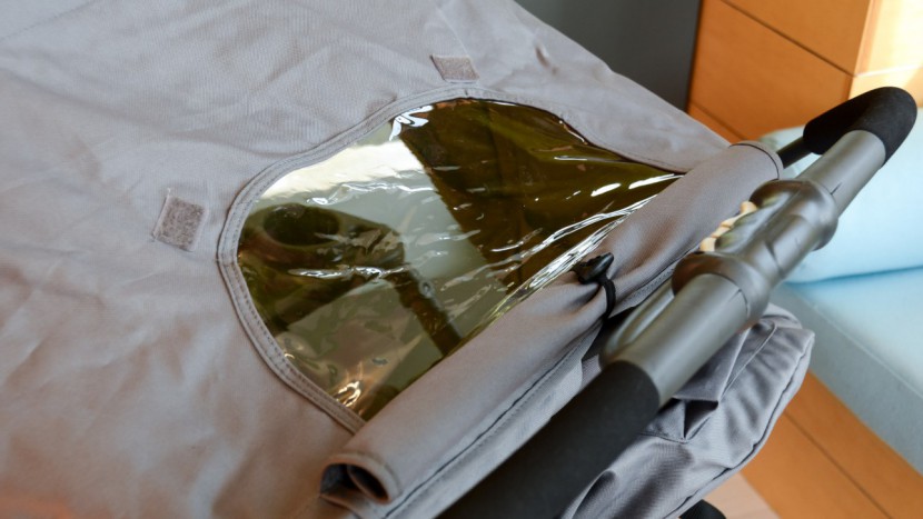 the scooter has a large canopy with a vinyl peek-a-boo window with...