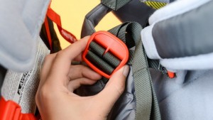 Tightening the shoulder straps for the child harness on the Kelty...