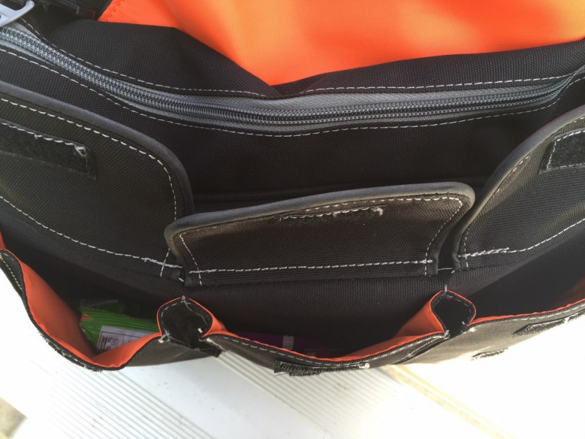 diaper dude messenger ii - front pockets of the diaper dude messenger ii. the velcro closures...