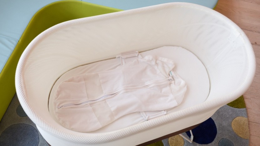 snoo smart sleeper - the included swaddles attach to the sides of the bassinet to ensure...