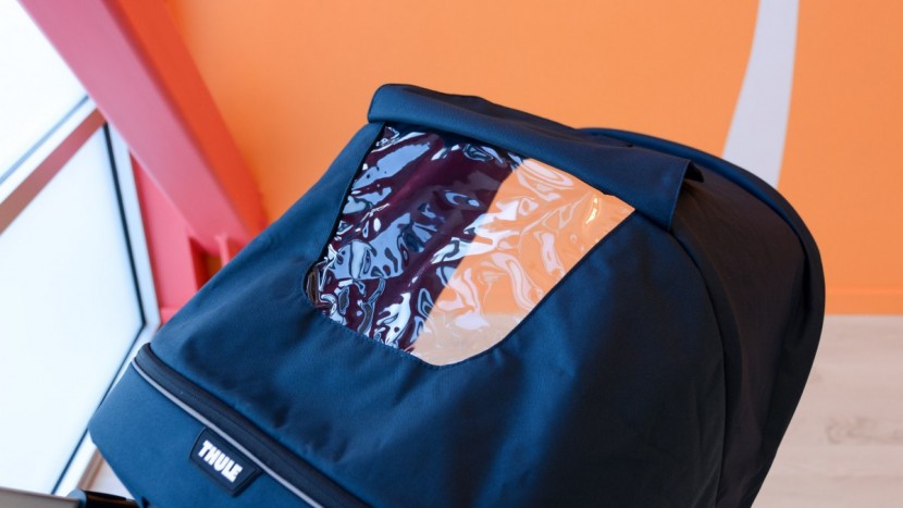 the thule has a vinyl peek-a-boo window with a cover that has a...