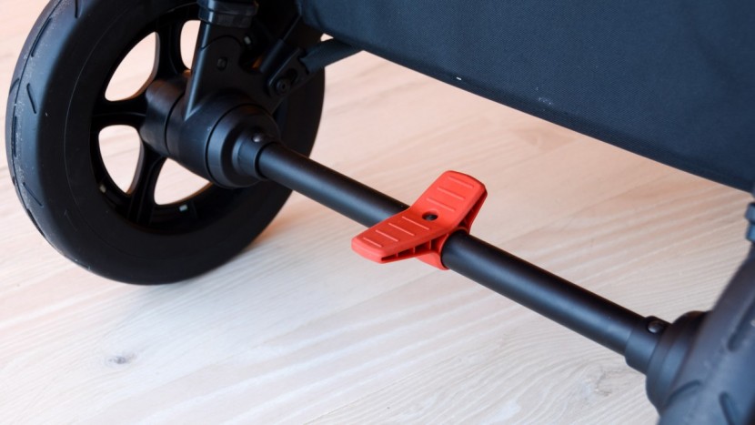 thule sleek double - the sleek has a rocker style brake pedal in the middle of the rear...