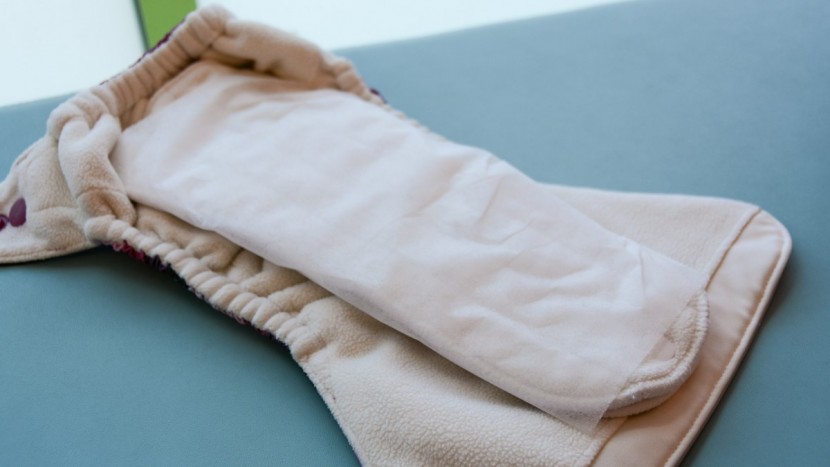 on some diapers, such as the grovia o.n.e., you may need to wrap or...