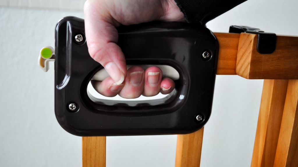 baby gate - the summer stairway gate latch/handle is a squeeze and lift...