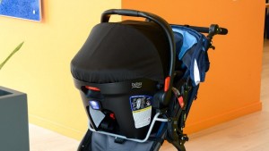 The infant car seat carrier clicks onto the adapter frame but also...