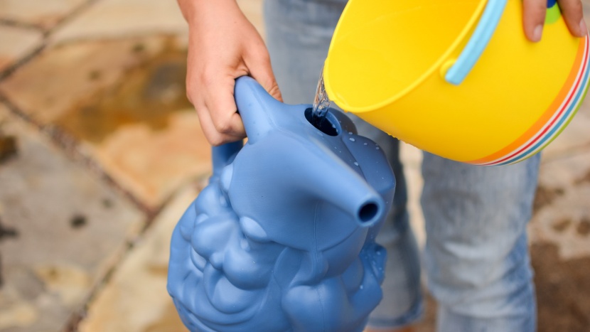 kid watering can - besides using a hose to refill the watering cans, we found it...