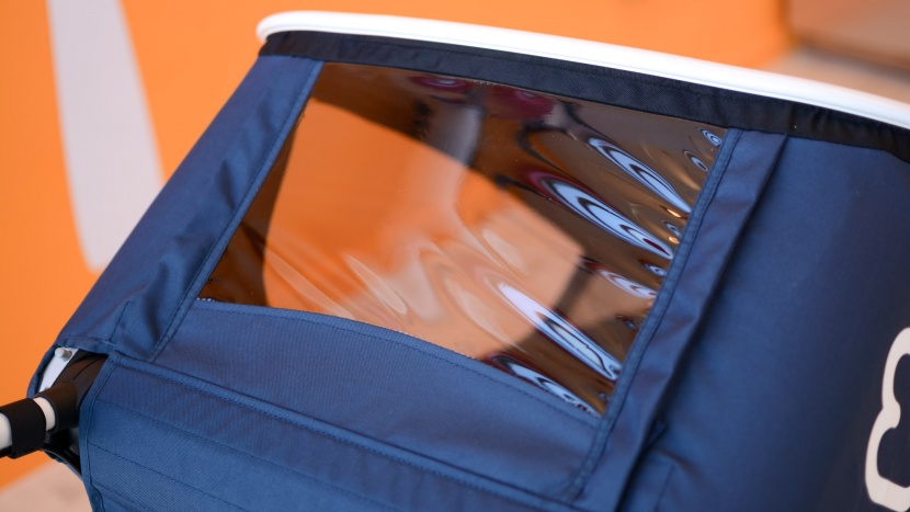 the hamax 2020 has a vinyl peek-a-boo window behind the handlebar.