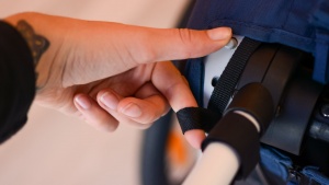 The Hamax fold method initiates by pressing the button and pulling...