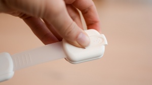 The unlock on the Goodv Adhesive Adjustable Strap is a slide switch...