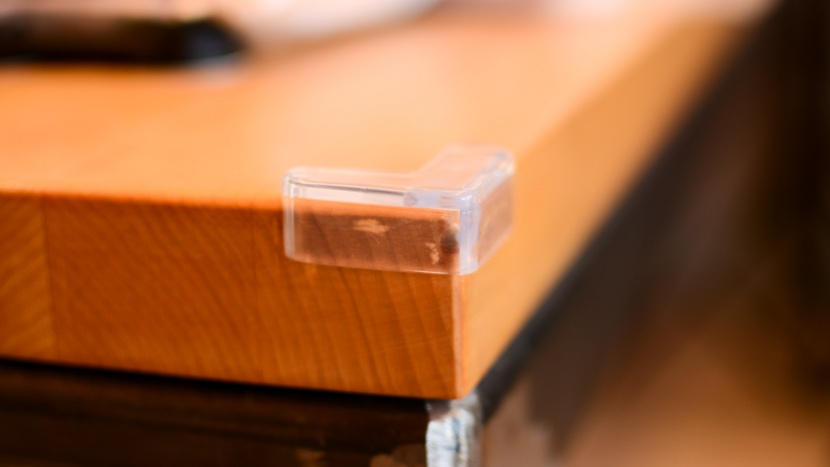 edge guards - the clear corner guards might draw less attention from little ones...