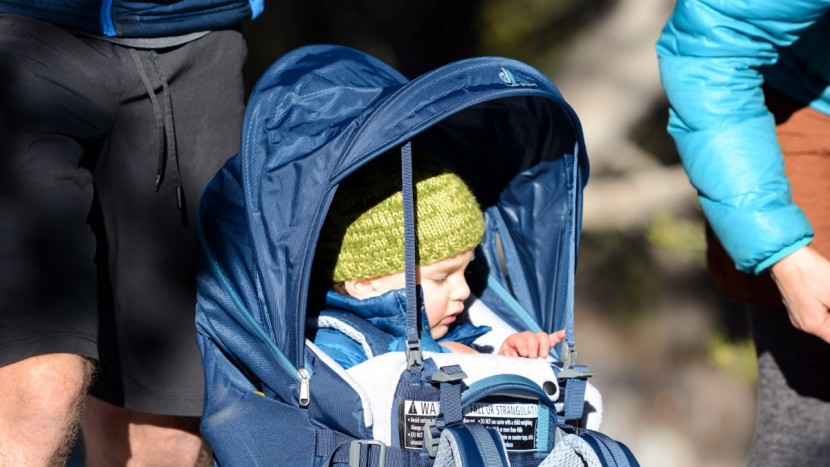 the canopy on the pro attaches in the front using plastic clips.