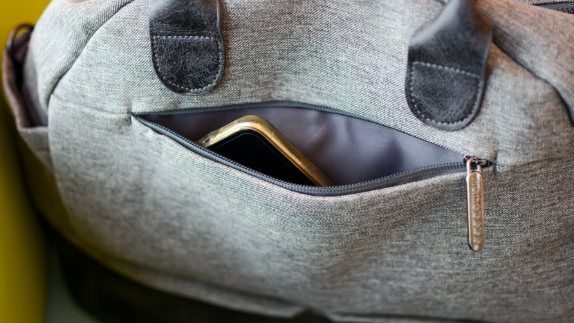 a smaller sized "mom pocket" on the outside of the bag is hand for...