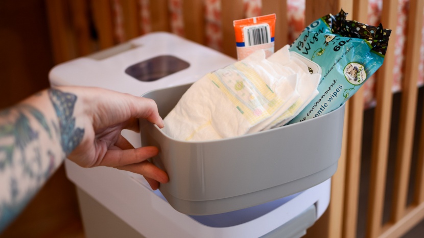 skip hop nursery style - the storage bucket must be removed from the top of the lid before...
