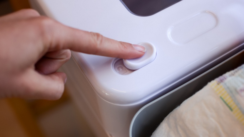 skip hop nursery style - a simple sliding tab locks the lid of the skip hop.