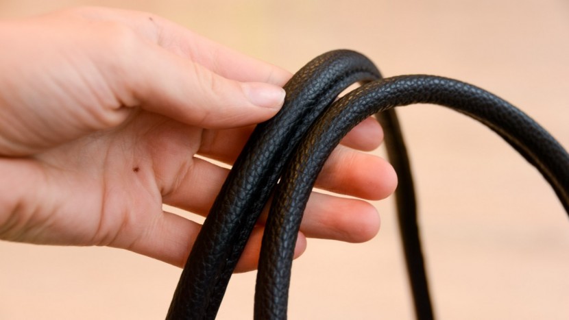 the rolled imitation leather on the shoulder/tote straps is...