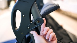 The Joovy has an auto-lock for the fold, and it is easy to release.