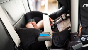 The vehicle lap belt goes across the foot portion of the Nuna...