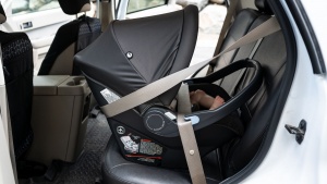 The vehicle shoulder belt wraps around the Peg carrier using the...