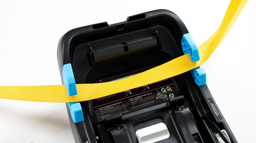 the vehicle belt threads through the color-coded slots on the side...