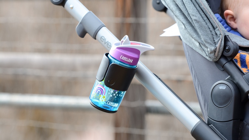 the evenflo has an open bottle holder that hangs off the side of the...