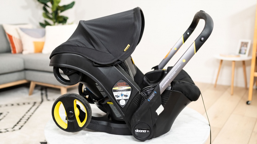 doona - the handle on the doona connects low on the carrier and is separate...