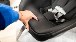 The Peg harness release button is located under the fabric with a...